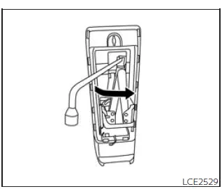 Nissan Frontier removing tool bag and loosening jack with wheel nut wrench
