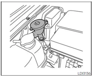 Nissan Frontier windshield washer fluid reservoir location and filling point